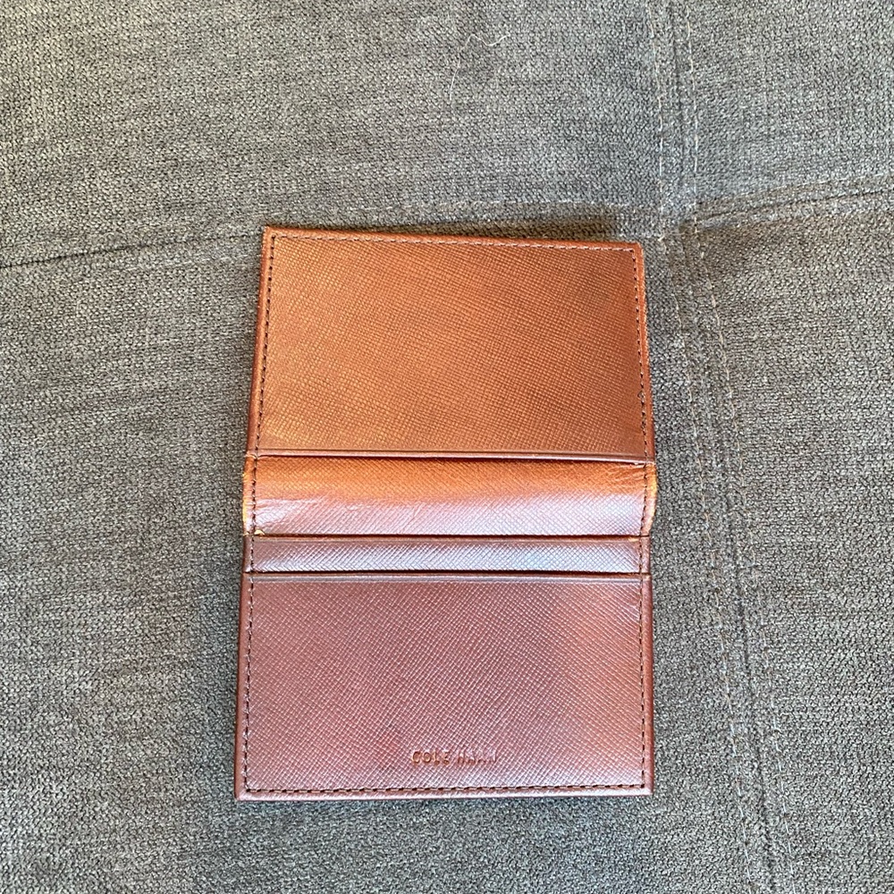 Men’s Cole Haan Logo Bifold leather card case. Brown, I D window.